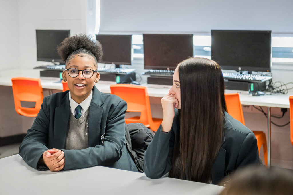 Two secondary school pupils in conversation