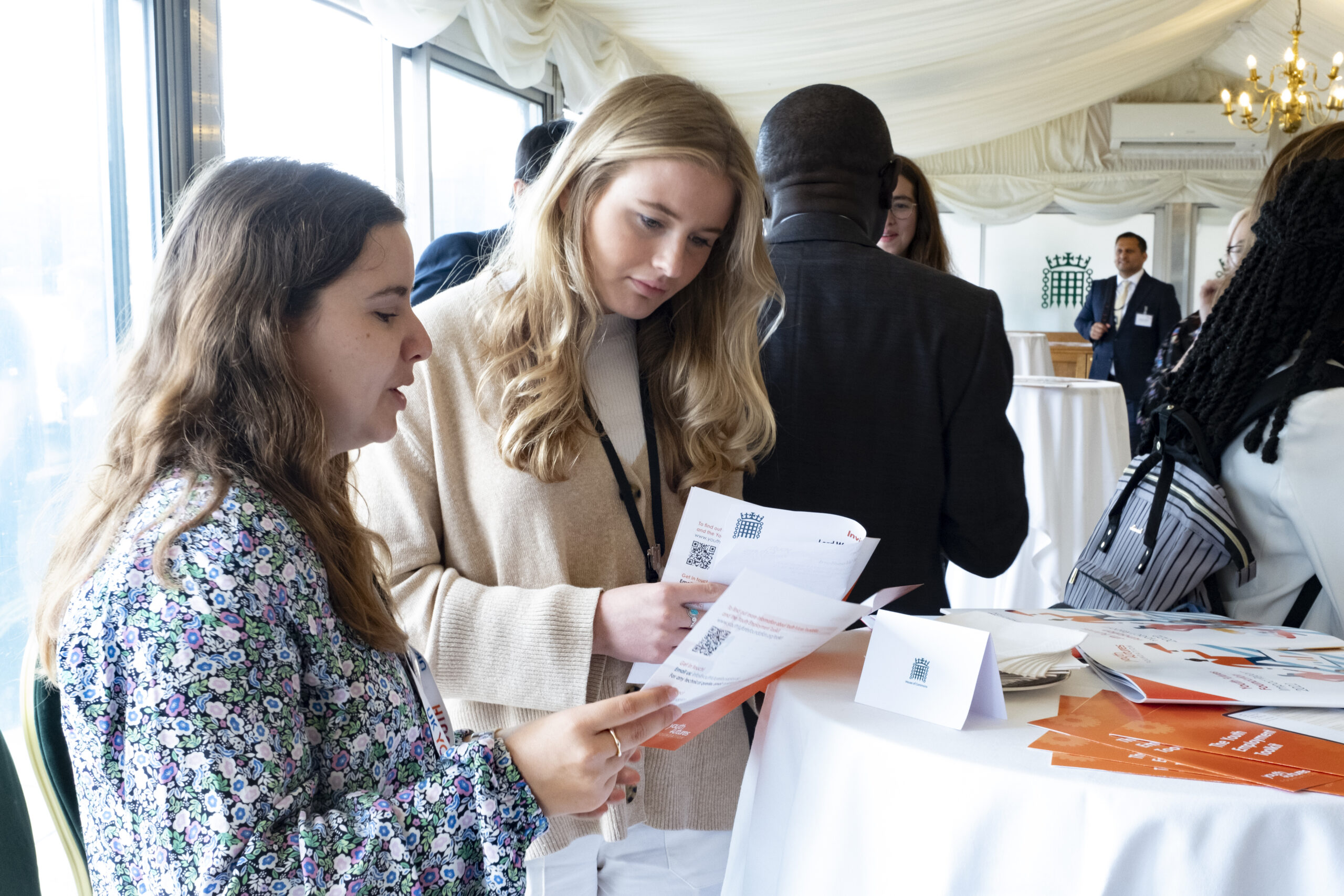 Stakeholder engaging with Youth Futures printed resources at event