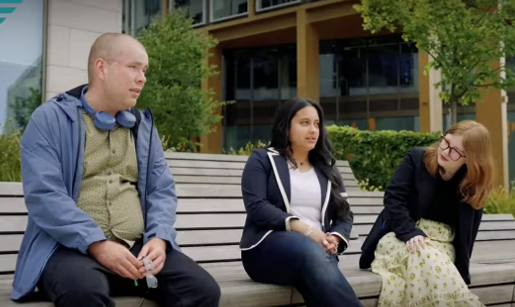 Three young people sitting on a bench