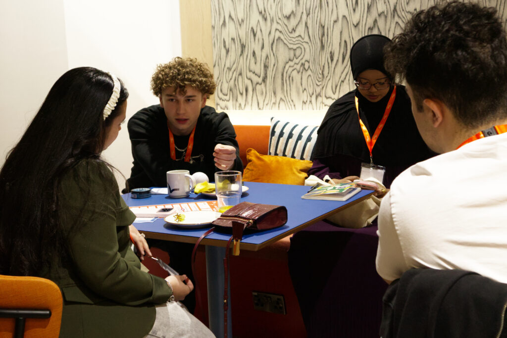 Four young people sitting round a table